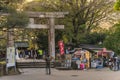 Stone torii gate of the Ueno TÃÂshÃÂ-gÃÂ« shrine beside the retro souvenirs store of Toshogu Daiichi Shop. Royalty Free Stock Photo